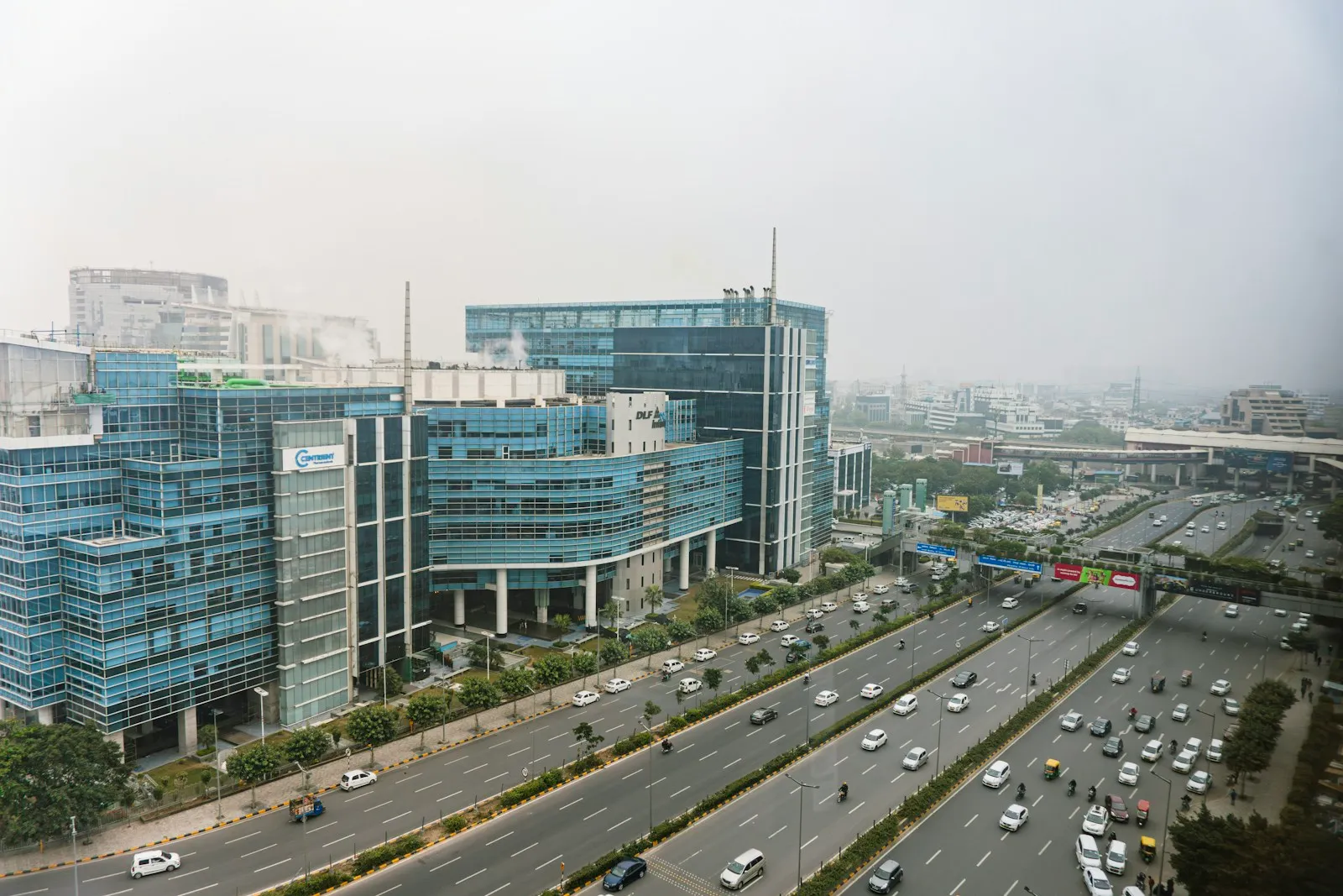 Office towers beside a multi-lane road in Gurugram